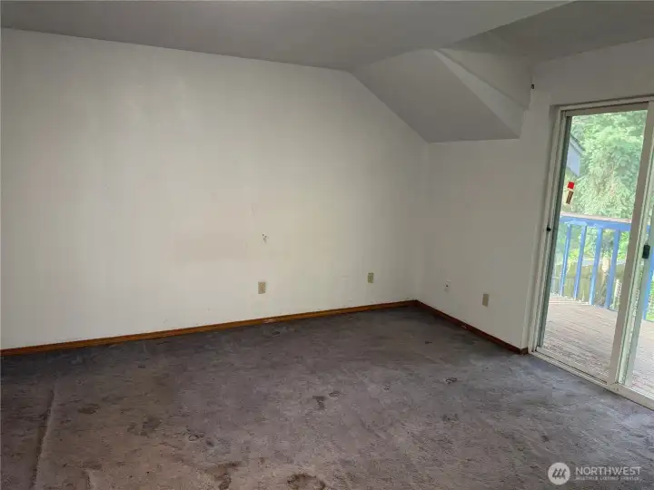 Primary bedroom looking towards the outside deck