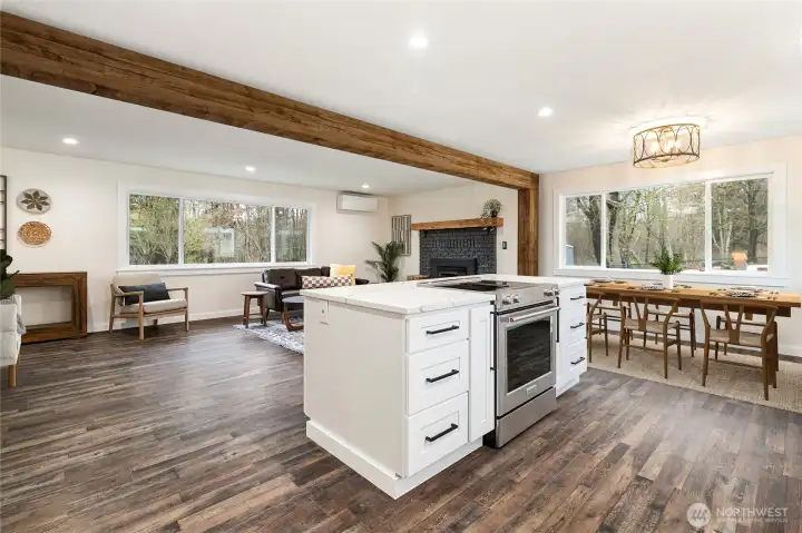 More cabinets and drawers in the island, including a hidden spice rack! A gorgeous down drafted range. A large dining space for gatherings.