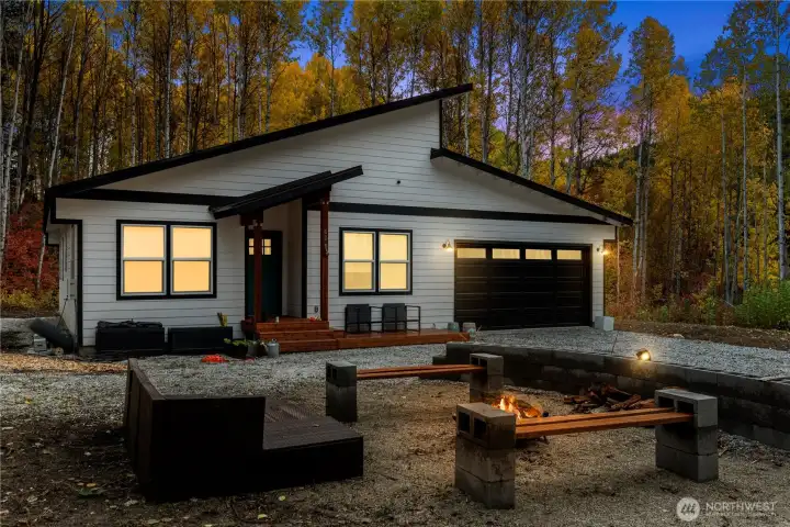 Clean architectural lines blend seamlessly with the natural landscape, creating a striking contrast between contemporary design and the warmth of the mountain setting.