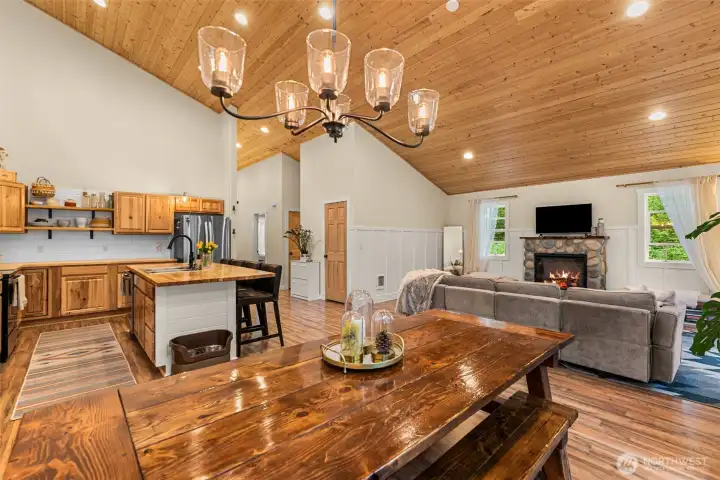 Large windows bring in soft natural light and views of the surrounding landscape, while the open layout creates an effortless flow ideal for gathering and relaxing.