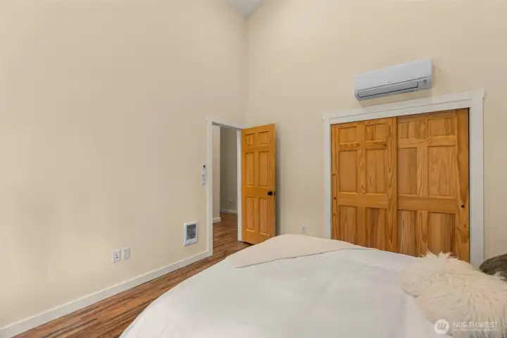 Crisp white millwork contrasts beautifully with the rich flooring, adding a clean modern touch to the warm mountain aesthetic. Thoughtfully styled with simple textures and calming tones, the space offers a comfortable and inviting retreat designed for rest and relaxation.