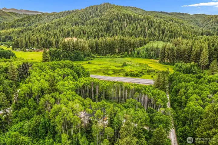 Towering evergreens, vibrant meadows, and expansive ridgelines create a breathtaking backdrop, while the secluded homesite offers a rare sense of peace and privacy.