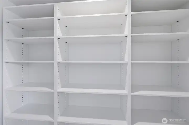 Walk-in pantry with custom shelving and ample storage space.