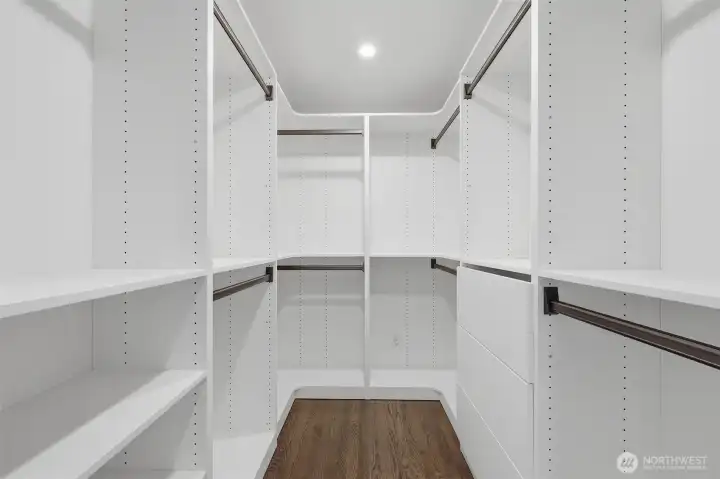 Stunning walk-in closet with custom built-in organization and ample storage space.