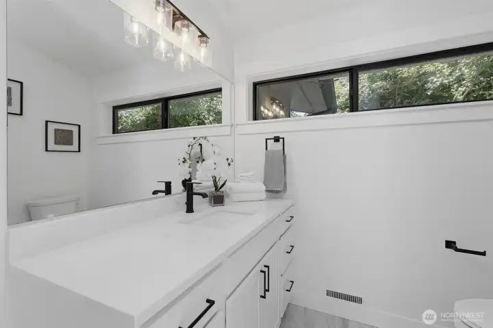 Spacious second bathroom featuring a large vanity, located on the main floor.