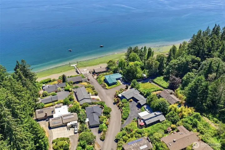 Aerial view showing the property from above, including the boat launch, dock, and community beach.