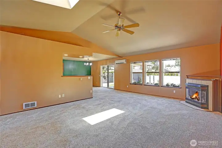The living room leading to the backyard is filled with natural light throughout.