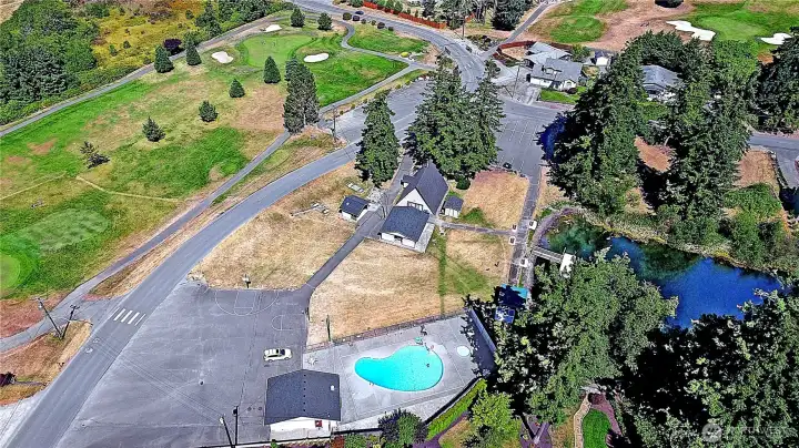 Aerial view of the golf course, Camaloch gated entrance, community Chalet, Pool #1 and the basketball courts.