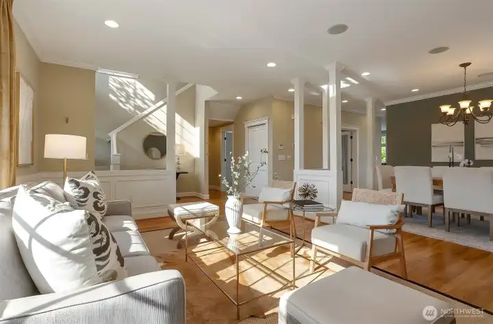 An impressive entry with soaring ceilings and a striking open staircase sets the tone for this thoughtfully designed home. The open living and dining areas flow seamlessly, complemented by a conveniently located home office and a stylish half bath.