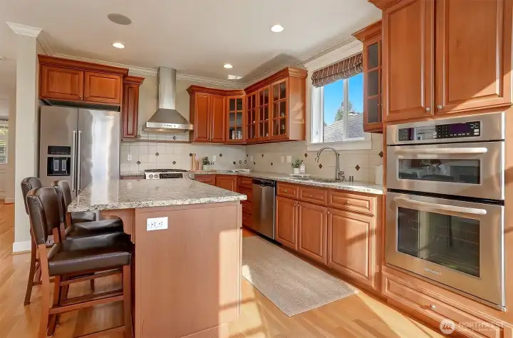 The chef’s kitchen delivers an exceptional combination of granite countertops, premium appliances, and custom cabinetry, providing a polished space for meals, gatherings, and daily living.