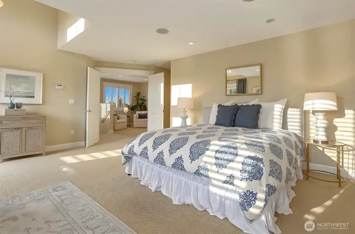 Double-door entry opens to an expansive primary suite with a private deck, generous walk-in closet, and beautifully appointed bathroom.