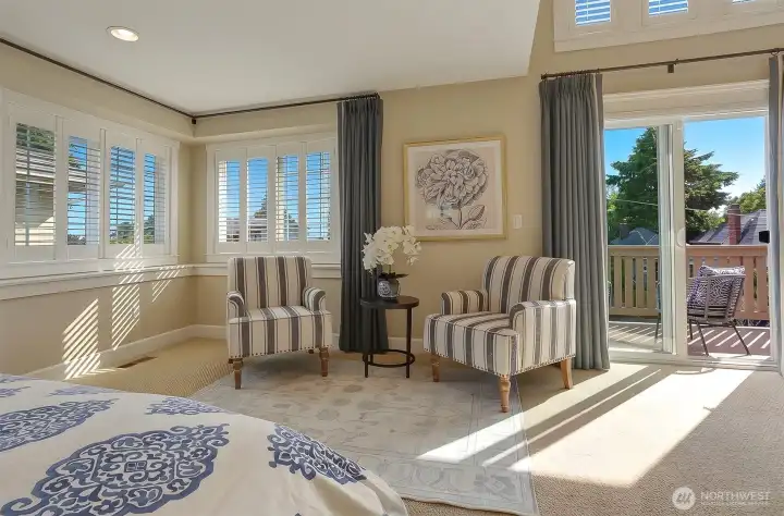 A serene west-facing primary retreat featuring French doors and a private view deck for enjoying Sunset Hill's spectacular evening skies.