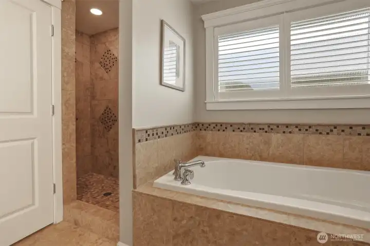 A separate soaking tub, shower, and enclosed toilet room provide comfort and privacy.
