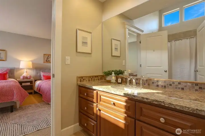 Guest bathroom conveniently located to serve both bedrooms.