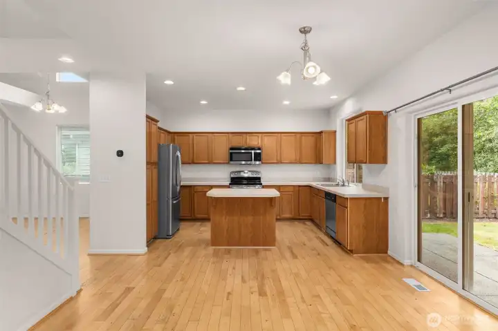 Kitchen with wood flooring and easy access to the staircase. Kitchen with wood flooring and easy access to the staircase.