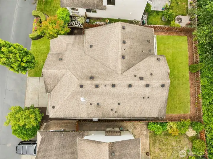 Aerial view highlighting the home's roofline and lot. Aerial view highlighting the home's roofline and lot.