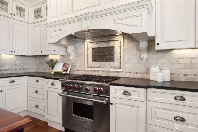 Gorgeous kitchen with a fantastic Wolf 6-burner propane range and oven. There's a second oven on the wall to the left.