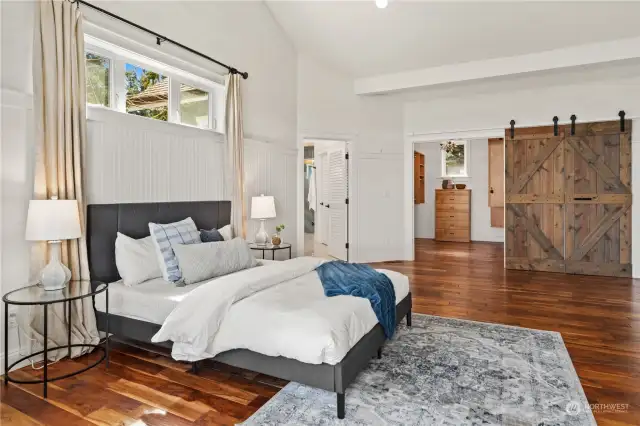 The spacious primary ensuite. Note the walk-in closet behind the barn door. The white door in the background leads to the 3/4 bath.