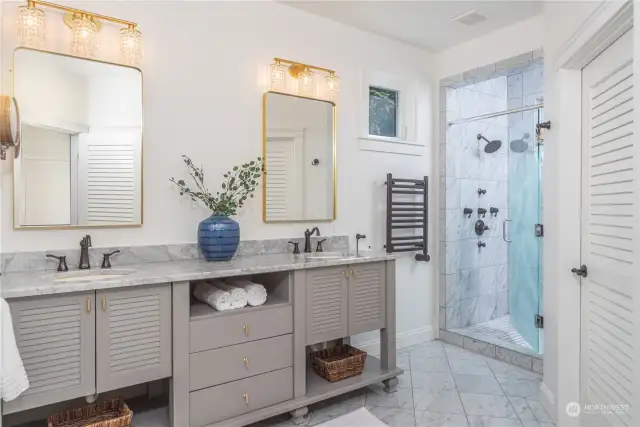 Heated tile floors, heated towel rack, large shower w/multiple shower heads and a private water closet in the primary ensuite.