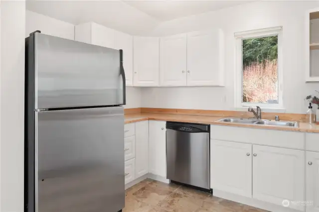 The full apartment kitchen has a fridge, dishwasher, double sink, and stove-top and oven. Plus lots of cabinets!