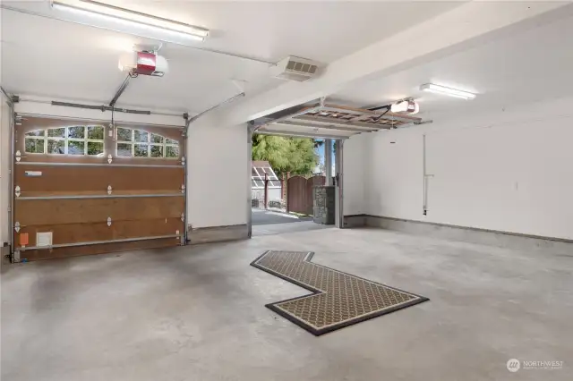 This 1,000 sq ft garage has it's own heating system, two bays, a washer/dryer and lots of cabinets.