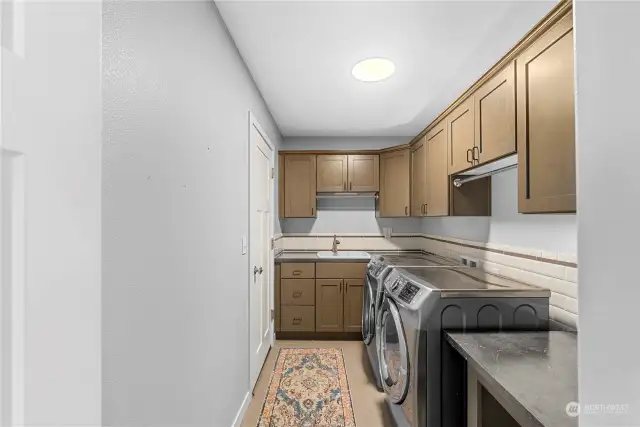 Nice sized laundry with plenty of storage and a sink. Door leads to the attached 2 car garage