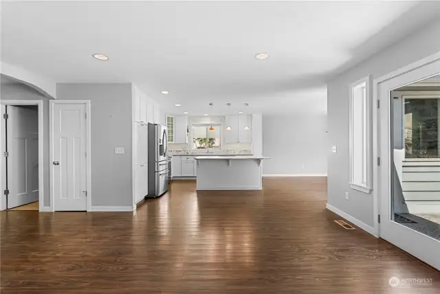 French doors to patio on right, open door leads to laundry and garage.