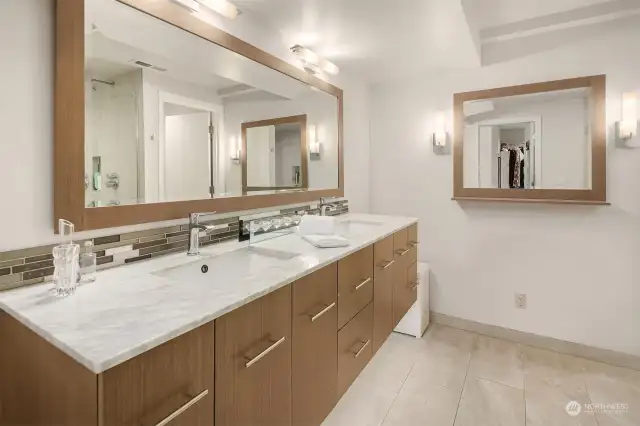 Fully and recently remodeled spa inspired bathroom with floating cabinets, dual vanities, stone floors, private water closet and a decadent wet room.