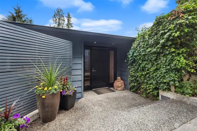 Classic Mid-Century modern entrance with lush vegetation and a Zen vibe.