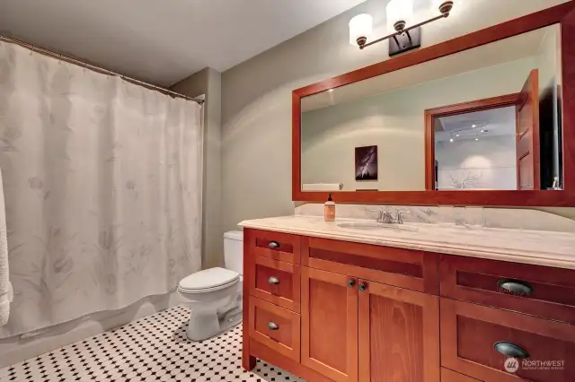 A full bathroom featuring a versatile tub/shower combo, perfect for relaxing baths or quick showers