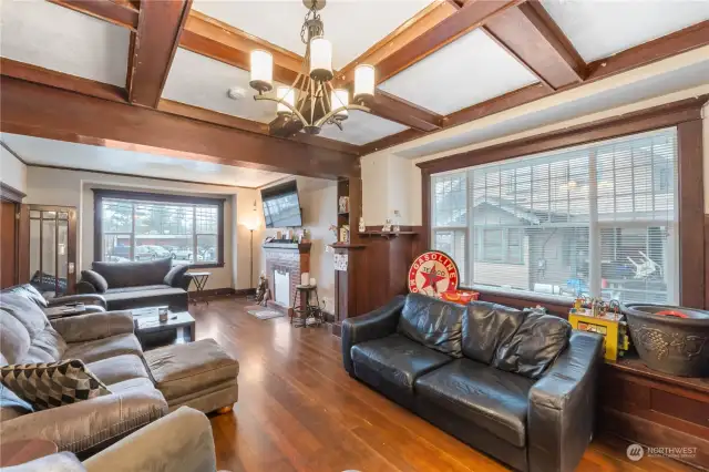 Formal dining space with original box beam ceiling, huge windows and bench seating (hidden)