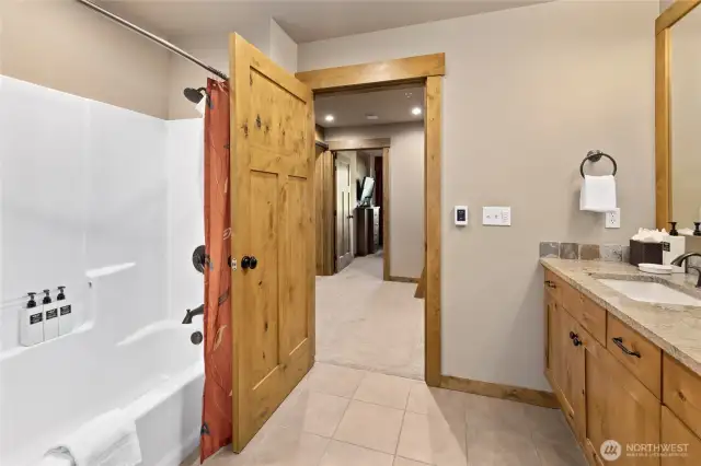 Guest bathroom has tub/shower combo.