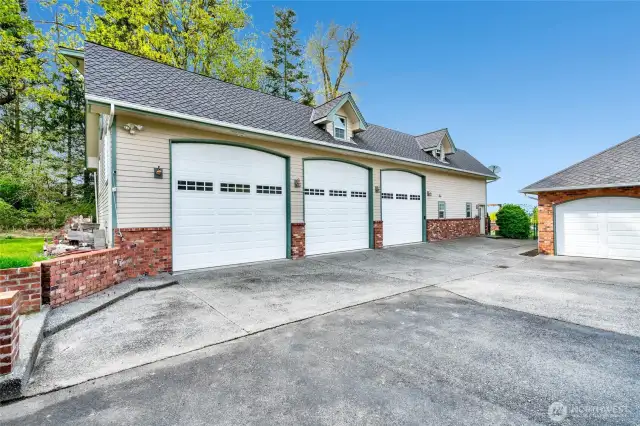 Detached garage with 3 bays, shop space and studio above.