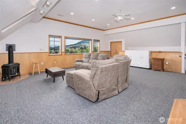 Furnished studio space with white Murphy bed and gas stove.