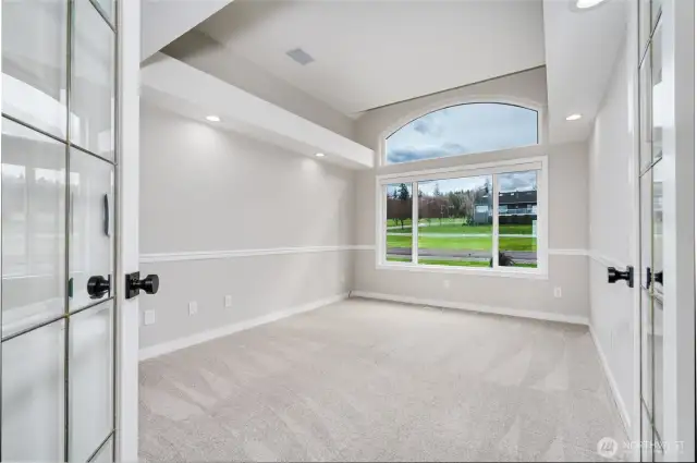 French doors open to office off of foyer, with interesting ceiling detail.