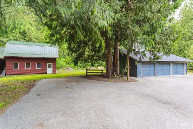 A barn and a three car garage/shop.