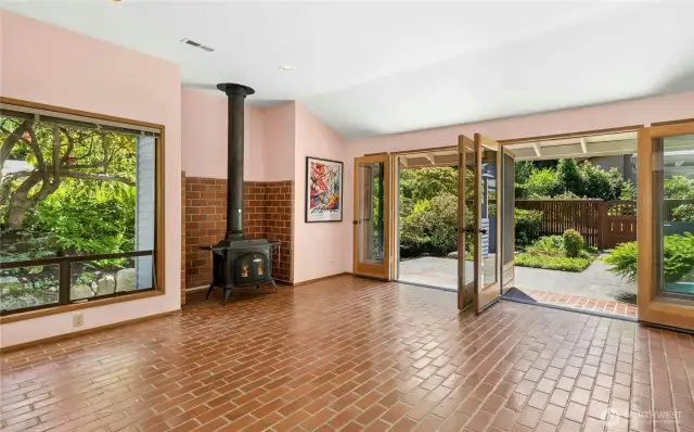 Great Room/Studio with wood burning stove opens to private courtyard garden