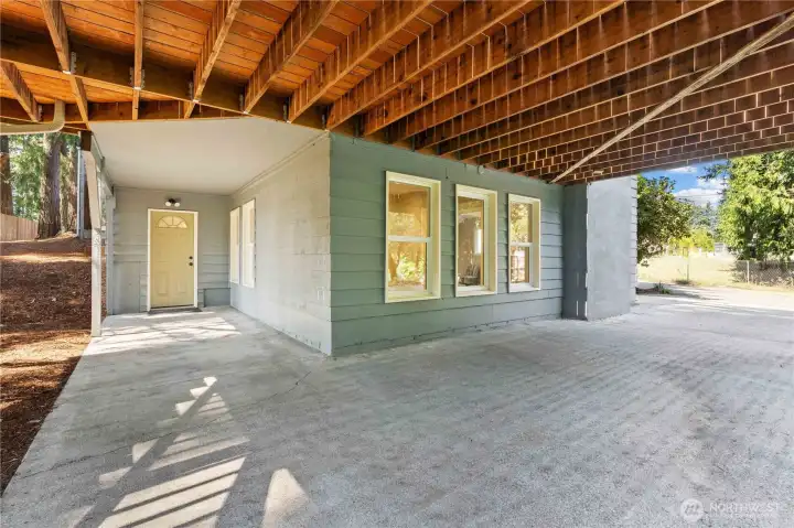 Here is your Covered Porch w/Access into the Basement. Perfect spot to relax on those rainy evenings in fall!