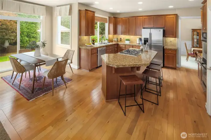 A nice breakfast nook off the left side of the kitchen w/ slider doors leading out to the back patio.