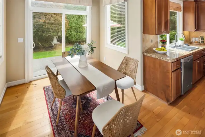 The breakfast nook & hardwood floors throughout the kitchen and entry way of the house