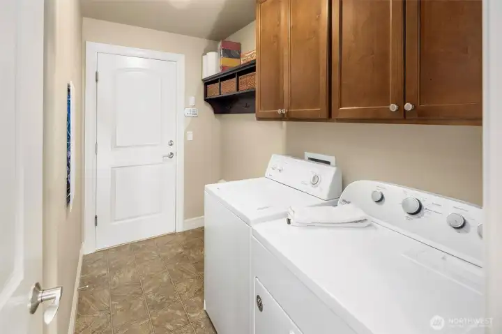 The big laundry room coming in off the garage with nice cabinet space, sink behind the door to the left, and full size laundery machines included.  Security System is there if you want it.