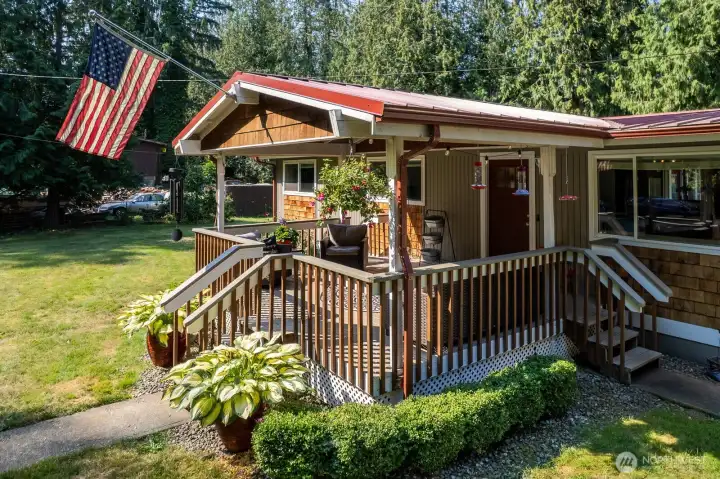 This wonderful front covered deck is a great space for being outside year round