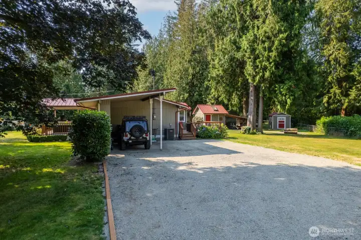 Entry into the property. Covered parking attached to the home and plenty of parking space for guests.