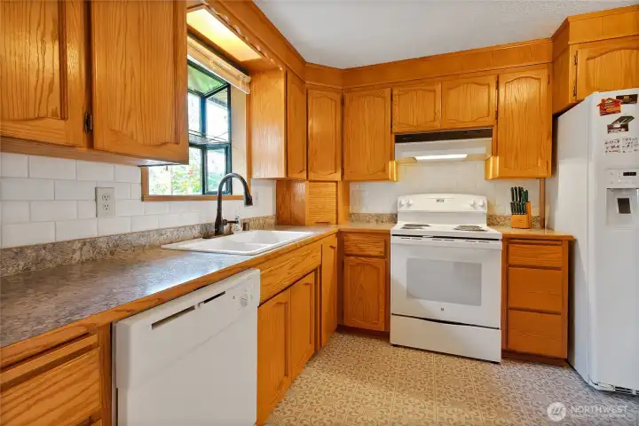 Kitchen with all appliances included and generous cabinetry for storage.