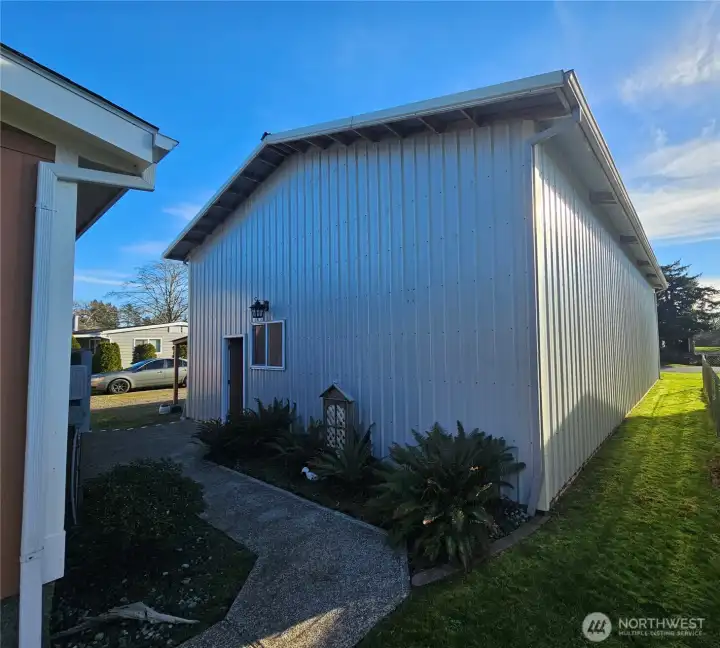 Beautifully manicured grounds with walkway from the house to the garage.