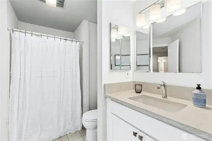 Bathroom got a makeover with modern touches – new floors, lights, vanity, and countertop.