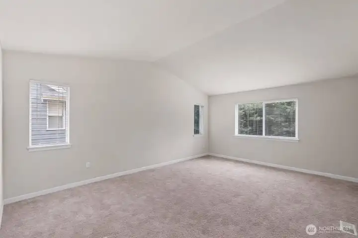 Primary bedroom as a blank slate. So much room for furniture, a seating area, or exercise equipment.