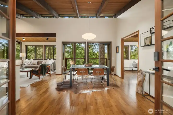 Tongue-and-groove ceilings mirror the warm hardwoods underfoot.  Sliver clerestory windows add filtered light and architectural interest in the living and dining area.