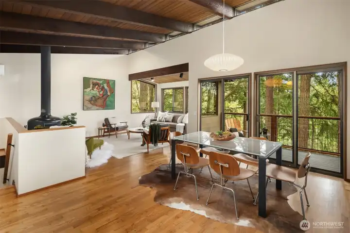 Stairs on the left lead to primary suite, two additional bedrooms, full bath, and laundry.  All three bedrooms enjoy sliders to the lower deck, which spans the entire length of the home.