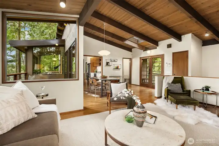 The deck off the dining area is nestled in between living room and kitchen, with windows in both rooms looking across the deck allowing for a sense of connectivity from room to room.